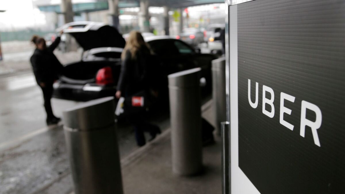 A sign marks a pickup point for the Uber service at LaGuardia Airport in New York.