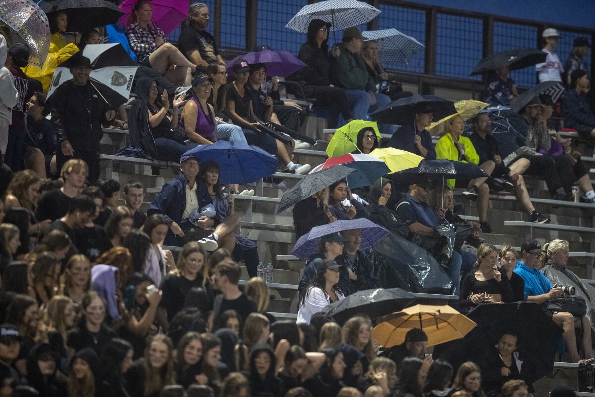 Marina fans brave the rain during a game against Fountain Valley at Huntington Beach High on Friday.