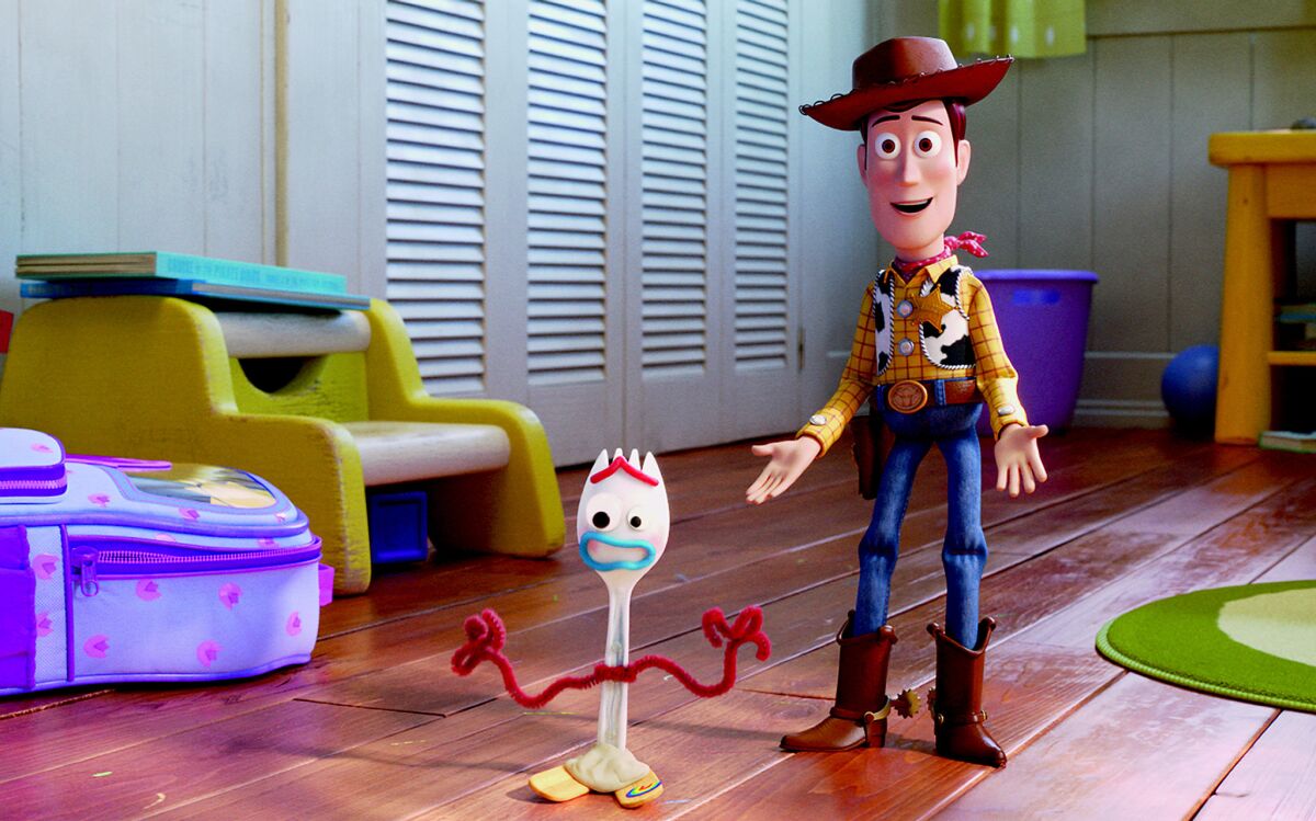 Forky (voiced by Tony Hale) and Woody (voiced by Tom Hanks) in "Toy Story 4."