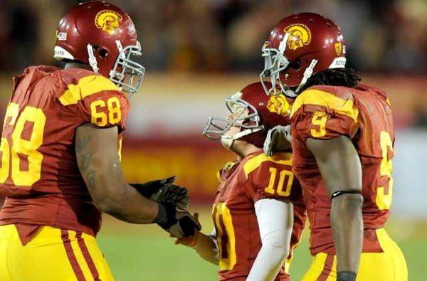 USC kicker Joe Houston (center) is congratulated by lineman Butch Lewis (68) and receiver David Ausberry after kicking the winning field goal in the fourth quarter Saturday night.