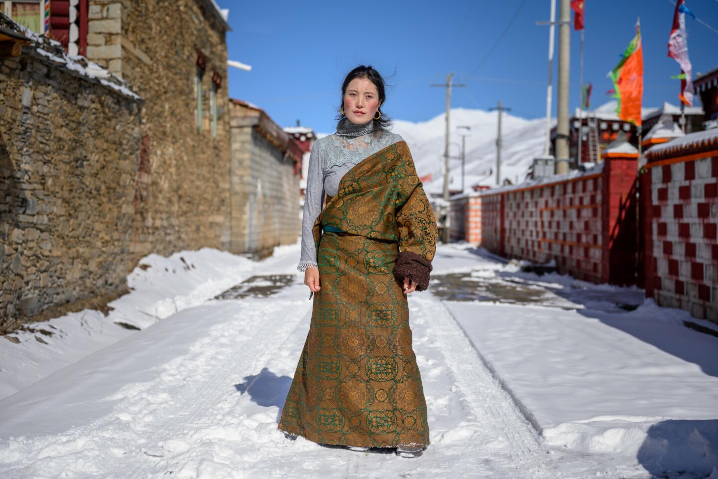 My Tibetan friend's sister, standing for a portrait in a Garze village on Jan. 24, 2020.