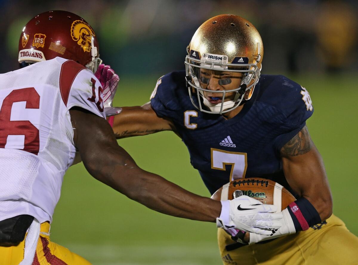 Notre Dame receiver TJ Jones tries to evade USC cornerback Anthony Brown after a reception in the first half Saturday.