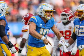 Chargers quarterback Justin Herbert (10) yells in  frustration after a drive stalls against the Chiefs.