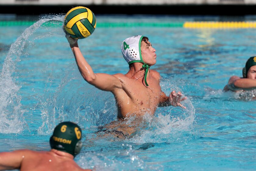 Costa MesaOs Wes Brazda (4) scores a penalty shot against Edison during the second half in a nonleague boys' water polo game in Huntington Beach on Tuesday. (Kevin Chang / Daily Pilot)
