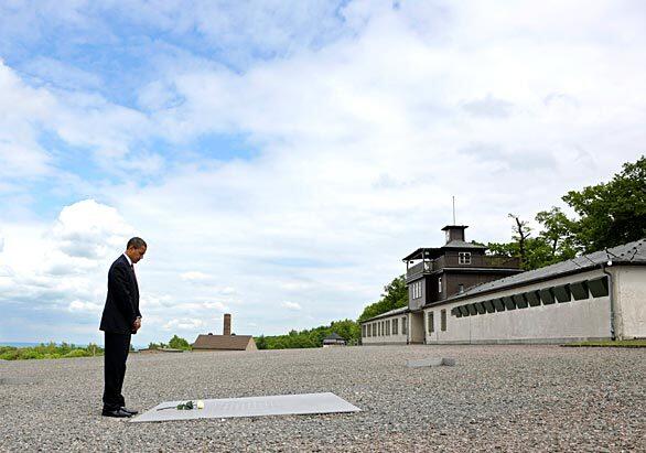 President Obama pauses for a moment of reflection after laying a white rose in memory of those who died at the Buchenwald World War II concentration camp in Germany.