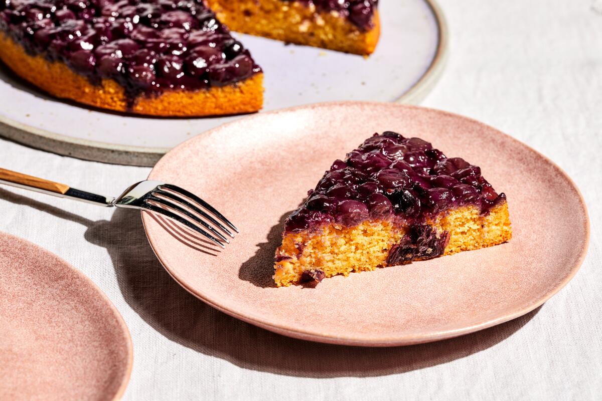 A grape and corn cake with a slice on a separate plate