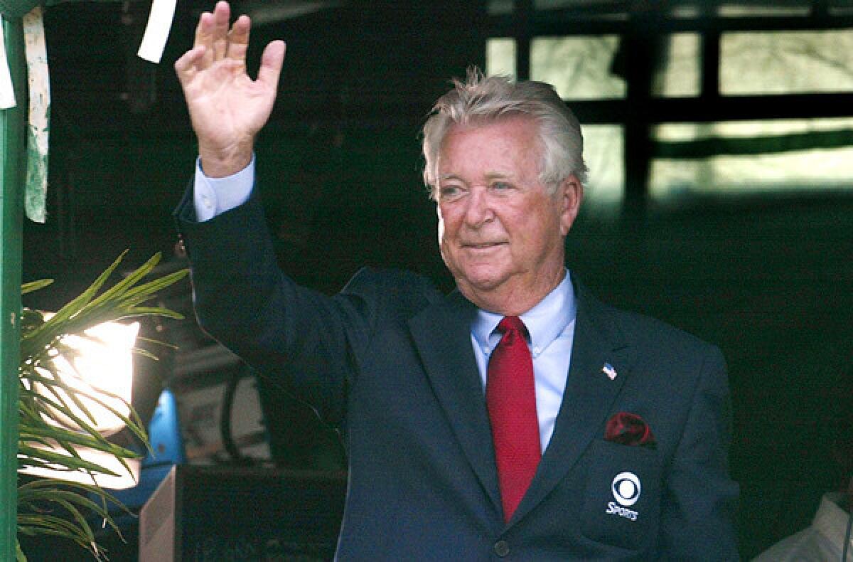 Ken Venturi waves to winner Bob Estes from the broadcast booth during the final round of the Kemper Open in 2002.