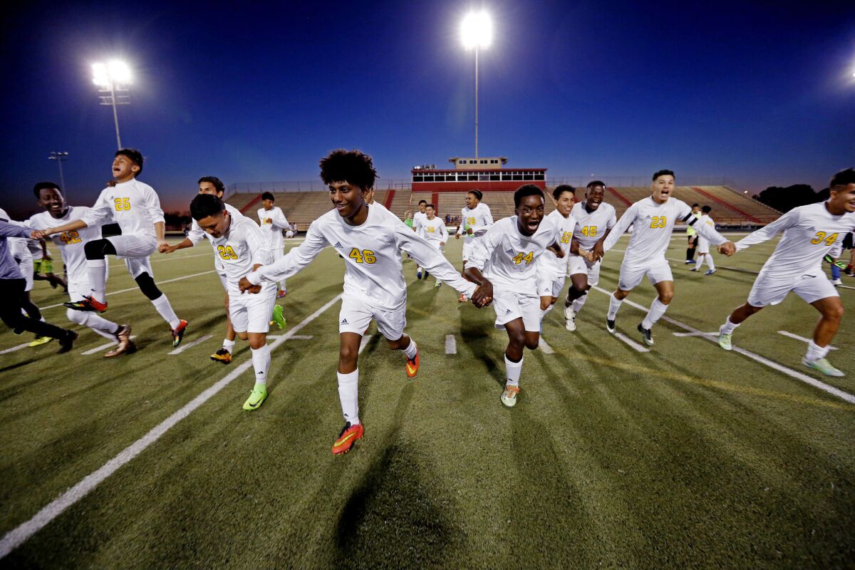 Soccer players from Margaret Long Wisdom High School in Houston celebrate an undefeated season.