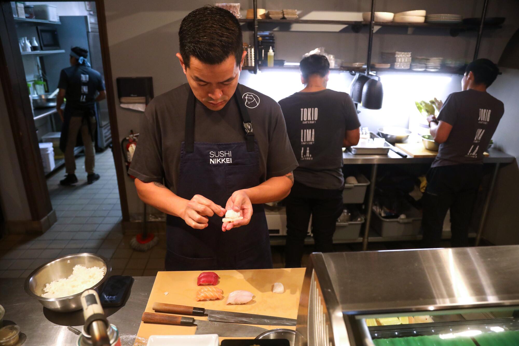 Chef Eduardo Chang prepares a sushi dish