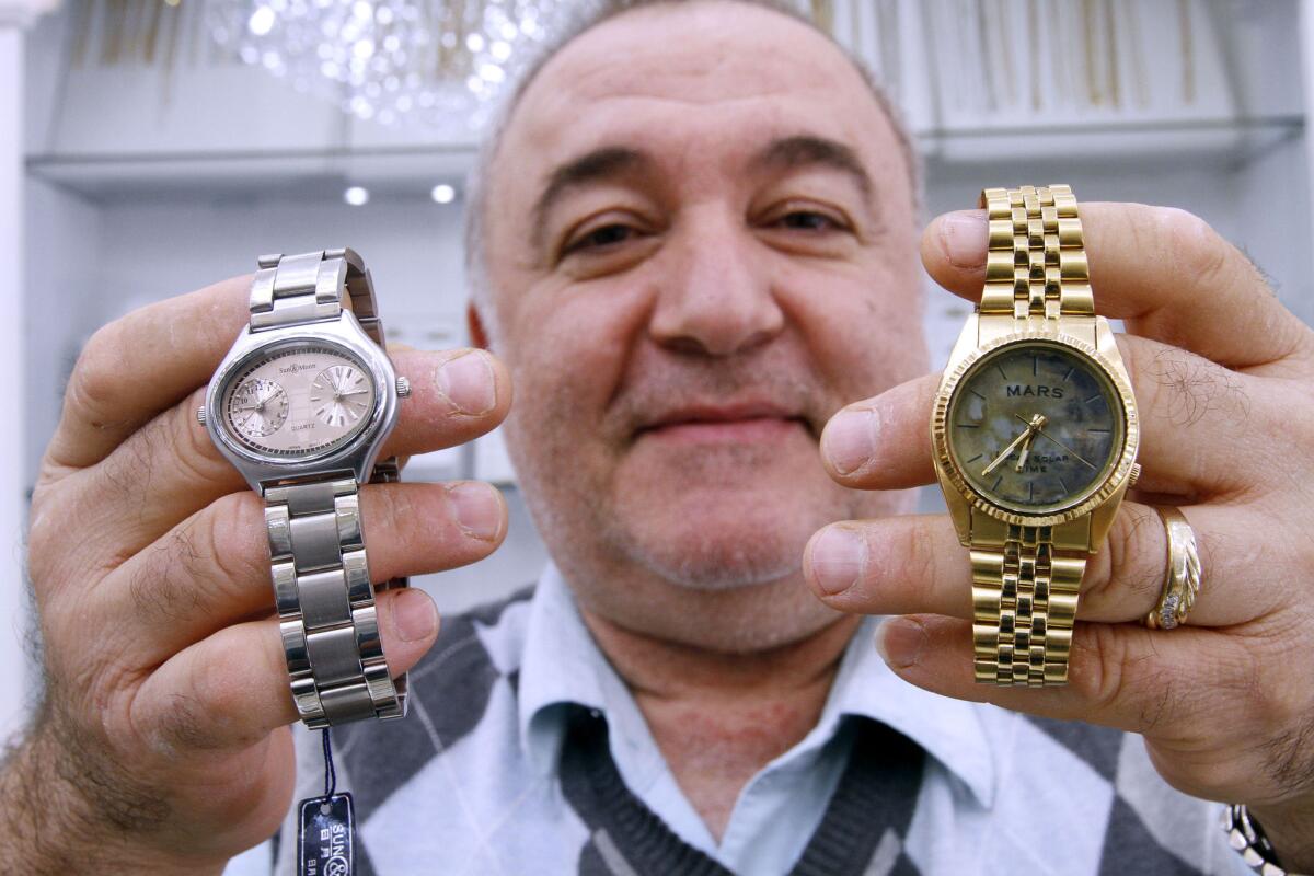 Garo Anserlian, owner of Executive Jewelers, shows a dual time watch with Earth/Mars time at left, and the original Mars time watch that loses about 40 minutes a day, at his watch store in Montrose on Tuesday, Oct. 29, 2013. JPL originally ordered the Mars-time watch for the 2004 Mar rover landing.