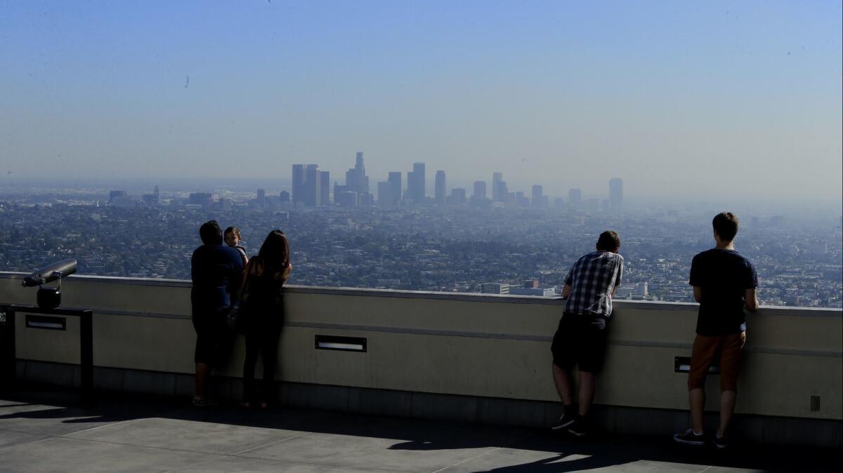 President Trump issued a directive intended to make it easier for states and businesses to comply with federal air quality standards. Above, visitors to Griffith Park take in a smoggy Los Angeles skyline.