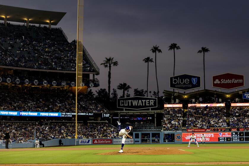 LOS ANGELES, CA - MAY16, 2024: Dark clouds loom over Dodger Stadium as Los Angeles Dodgers pitcher Tyler Glasnow (31) pitches to the Cincinnati Reds in LA's 7-2 loss on May 16, 2024 in Los Angeles, California.(Gina Ferazzi / Los Angeles Times)