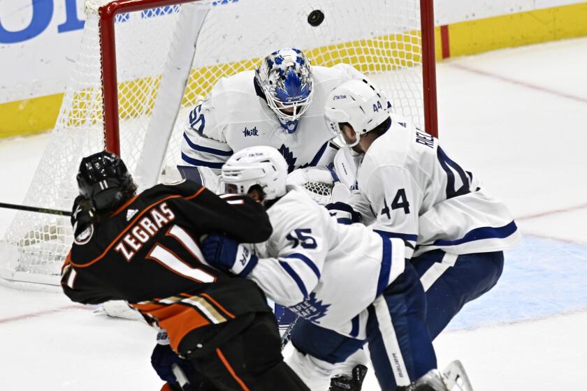 Anaheim Ducks center Trevor Zegras (11) scores on a shot past Toronto Maple Leafs goaltender Erik Kallgren.