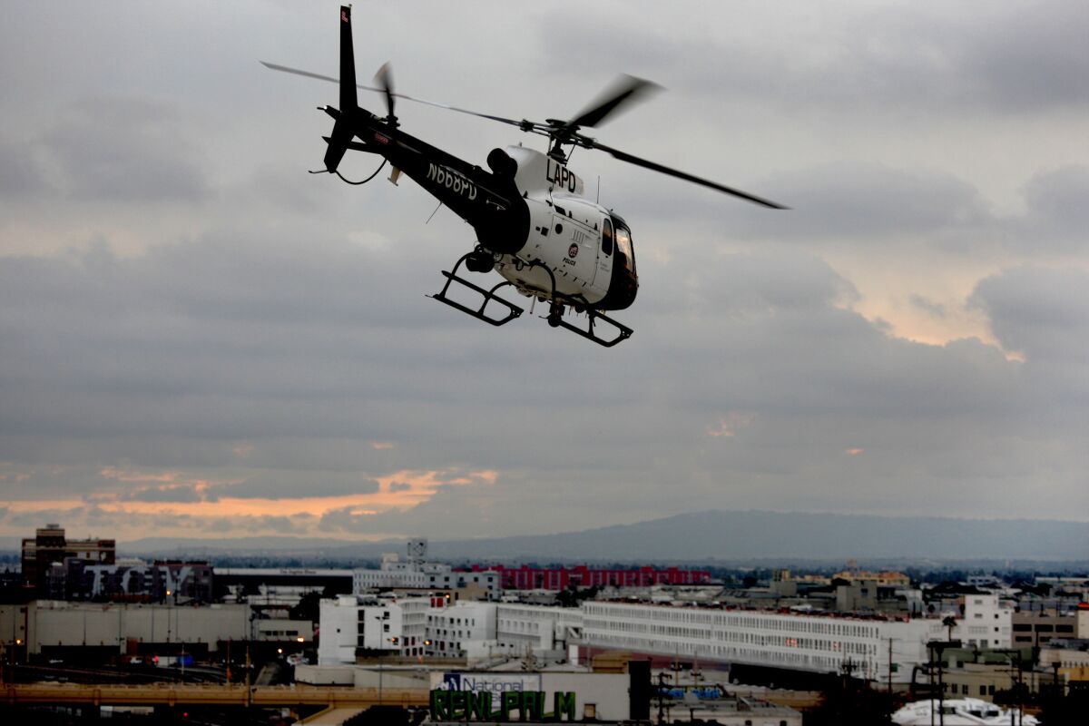 An LAPD helicopter flies over downtown Los Angeles, where the department is pioneering the use of choppers to prevent crime.