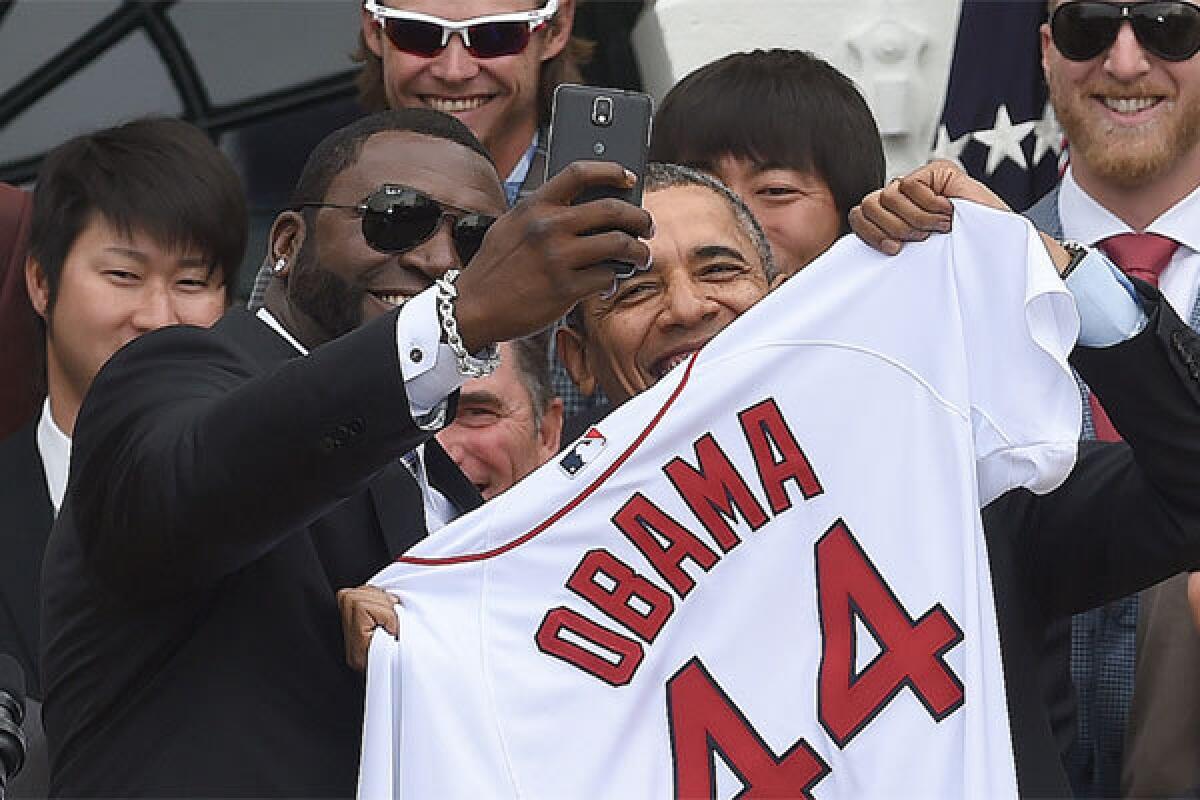 Boston designated hitter David Ortiz takes a selfie with President Obama during a ceremony at the White House.