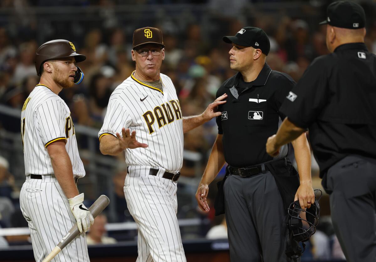Padres manager Bob Melvin joins Brandon Drury to argue a strike call with umpires in an Aug. 23 game against the Guardians.