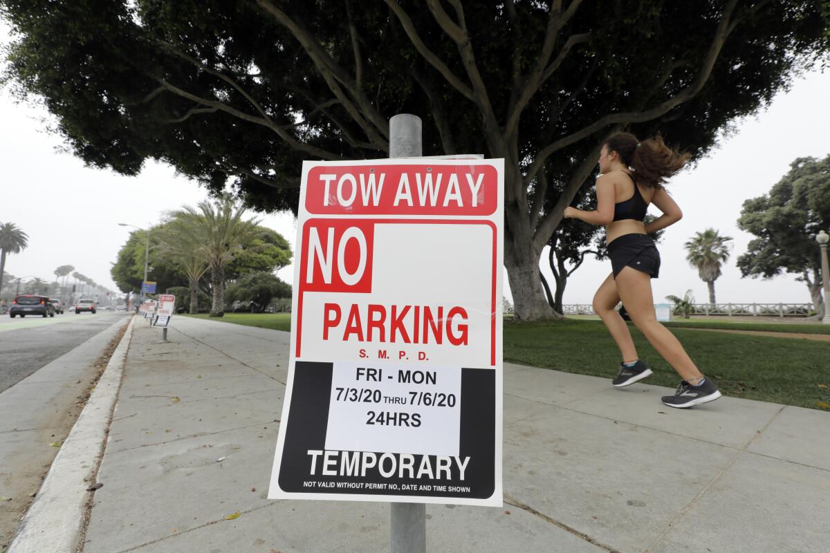 No parking signs from the Fourth of July weekend still block spots on Ocean Avenue in Santa Monica on Monday.