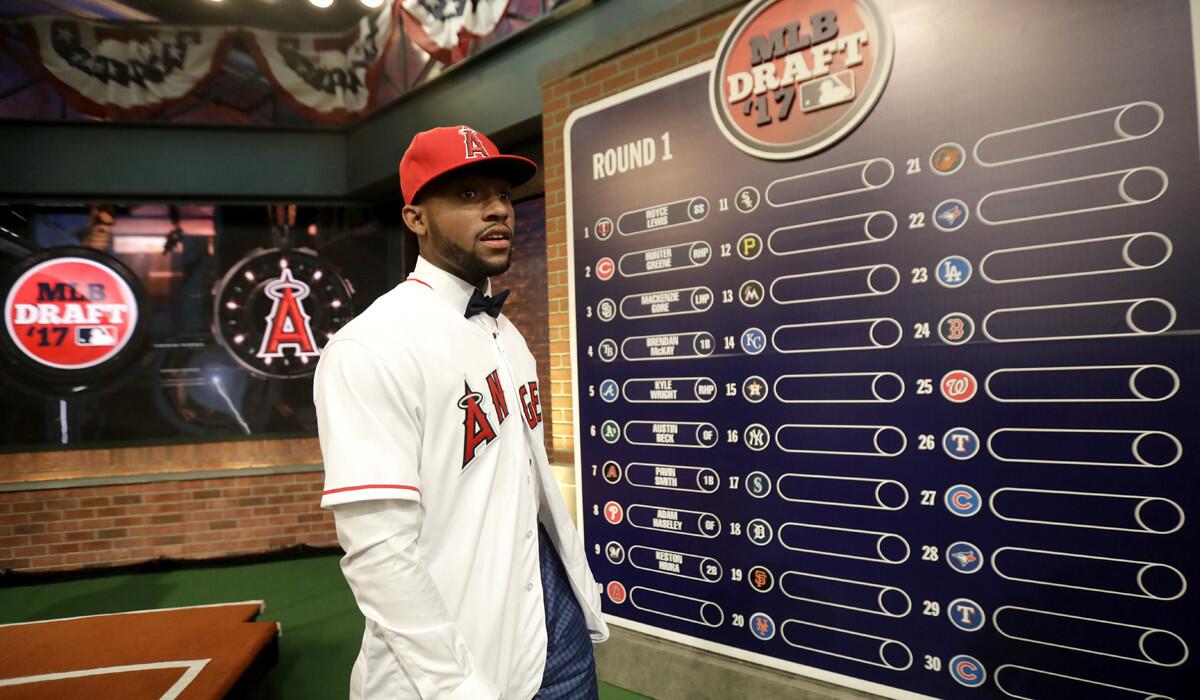 Jordon Adell, an outfielder and pitcher from Ballard High in Louisville, Ky., walks off the stage after being selected No. 10 by the Angels in the first round of the Major League Baseball draft on Monday.