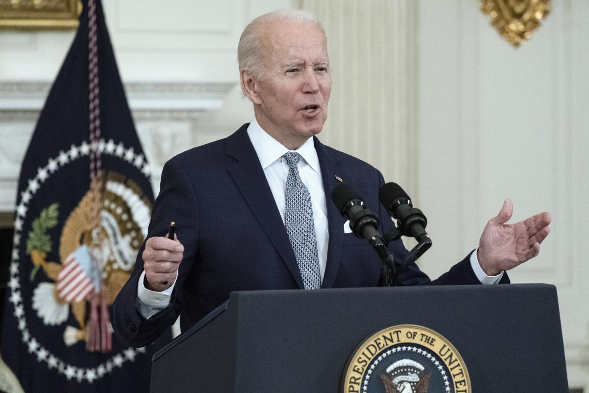 President Biden speaks at a lectern.