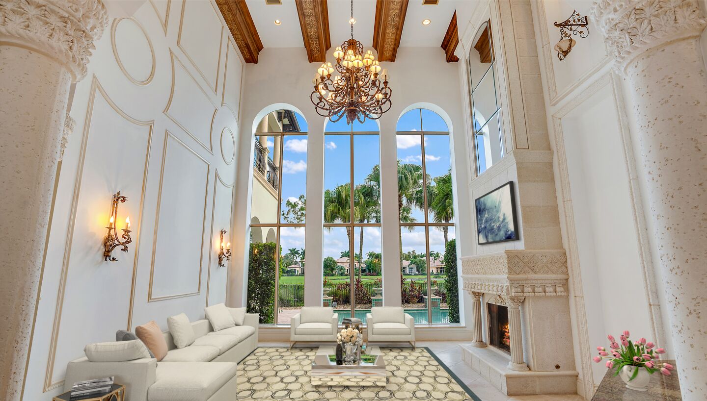 The two-story home enjoys golf course views from a second-story balcony and a covered loggia.