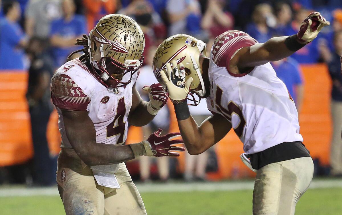 Florida State running back Dalvin Cook. left, celebrates with wide receiver Travis Rudolph after scoring a fourth-quarter touchdown against Florida.