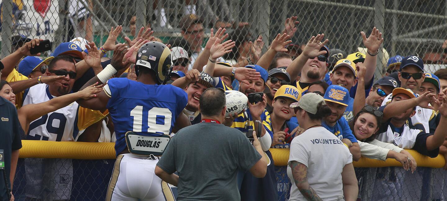 A large crowd of hopeful Los Angeles Rams fans greet St. Louis Rams wide receiver Kenny Britt as he takes the field for a combined practice with the Dallas Cowboys in Oxnard on Monday.