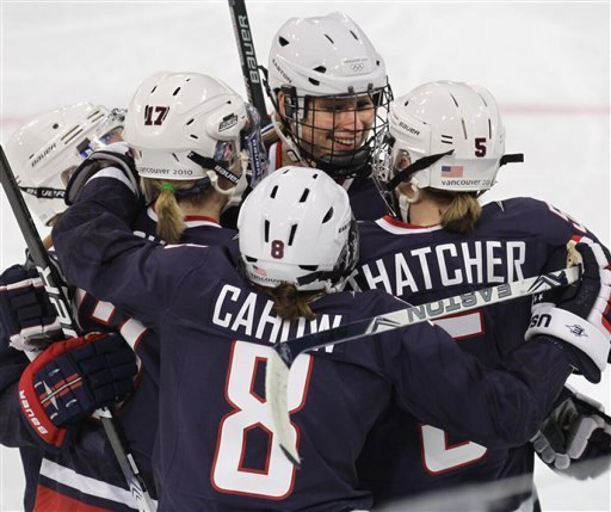 USA's defenseman Angela Ruggiero (4), center, celebrates with teamates Jocelyne Lamoureux (17), Caitlin Cahow (8), and Karen Thatcher (5) after scoring against China in women's preliminary round hockey play at the Vancouver 2010 Olympics in Vancouver, British Columbia, Sunday, Feb. 14, 2010. (AP Photo/Chris O'Meara)