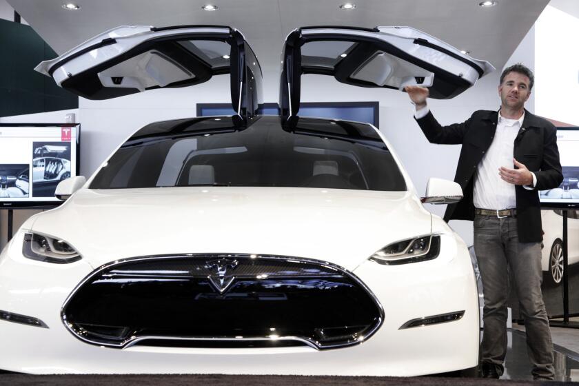 Franz von Holzhausen, chief designer at Tesla Motors, talks about the doors on the Tesla Model X in January 2013. The electric car maker's first SUV will be unveiled Tuesday night.
