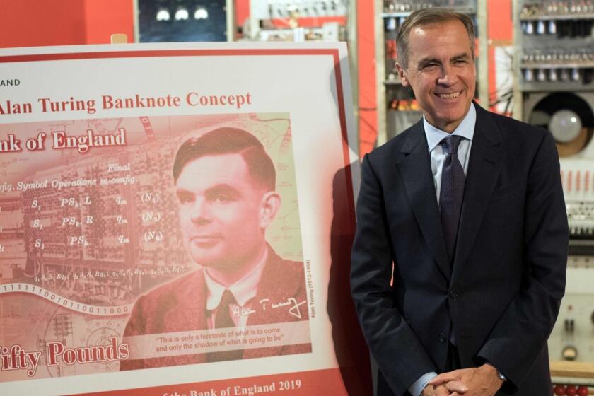 Mark Carney, governor of the Bank of England, poses for a photograph beside the concept design for the new Bank of England fifty pound banknote, featuring mathematician and scientist Alan Turing, during the presentation at the Science and Industry Museum in Manchester, north-west England on July 15, 2019. (Photo by OLI SCARFF / AFP)OLI SCARFF/AFP/Getty Images ** OUTS - ELSENT, FPG, CM - OUTS * NM, PH, VA if sourced by CT, LA or MoD **