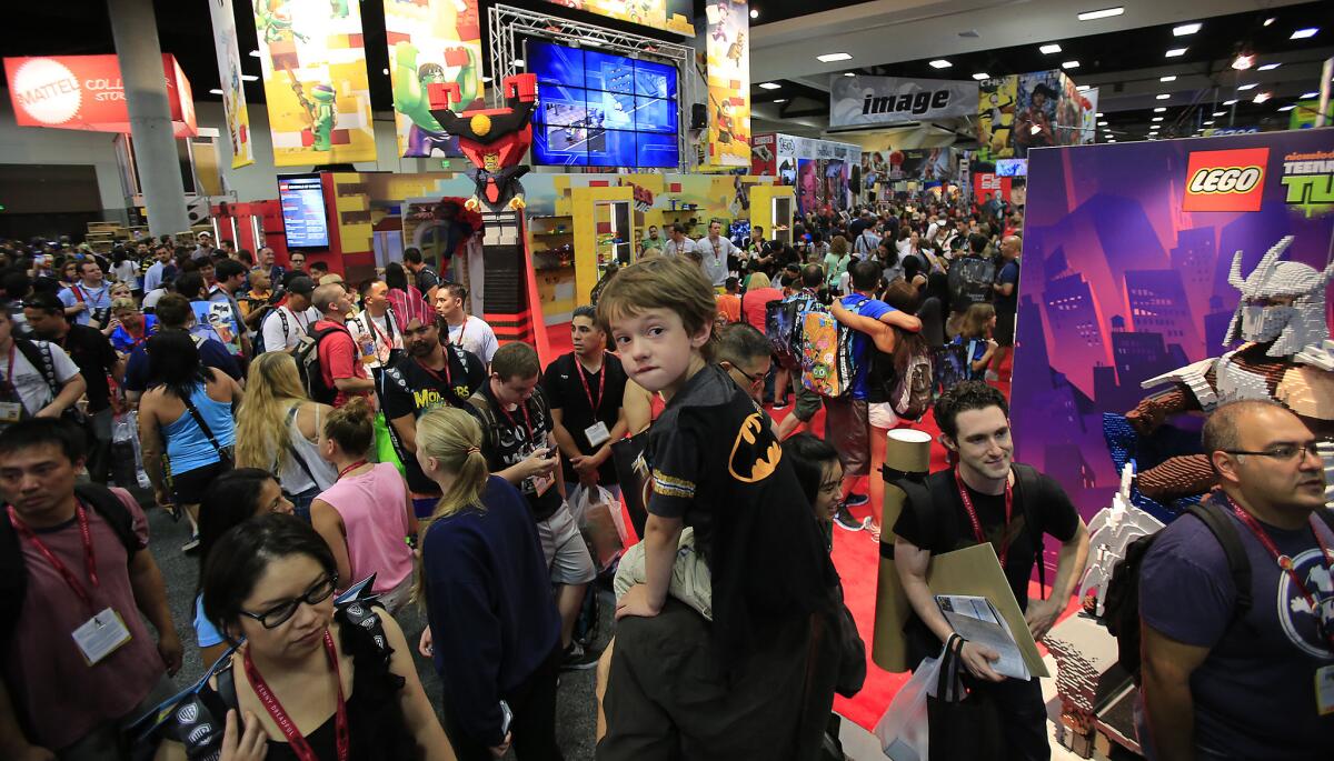 Zak Skelly rides on his father's shoulders through a packed San Diego Convention Center at Comic-Con International on July 23, 2014. The convention will remain in San Diego through 2018.