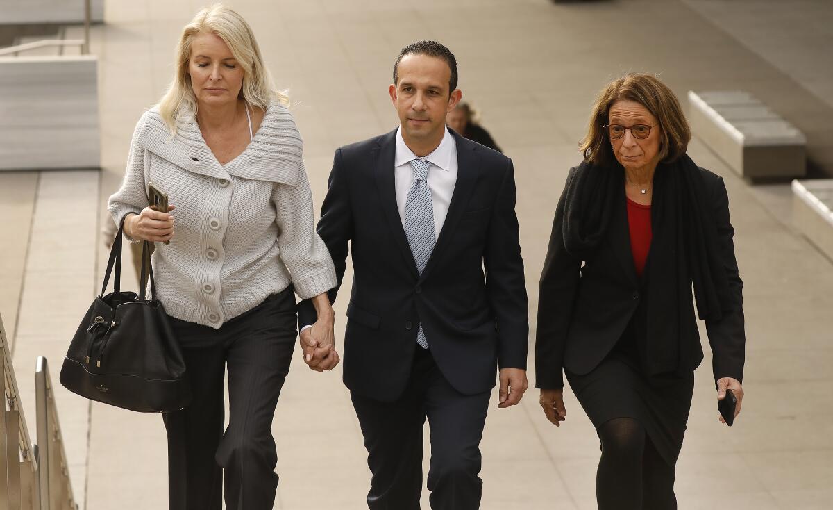 Former Los Angeles City Councilman Mitch Englander walks with his wife and attorney 