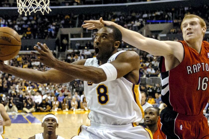 In this Jan. 22, 2006, file photo, Toronto Raptors' Matt Bonner can't stop Los Angeles Lakers' Kobe Bryant from getting to the basket in the first half of NBA basketball game in Los Angeles.