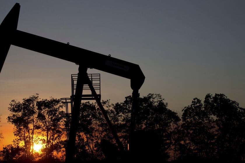 FILE- In this Feb. 19, 2015, file photo, the sun sets behind an oil well in a field near El Tigre, Venezuela. Ministers from the Organization of the Petroleum Exporting Countries and non-OPEC nations led by Russia meet in Vienna on Friday, June 22, 2018, and Saturday, June 23. (AP Photo/Fernando Llano, File)