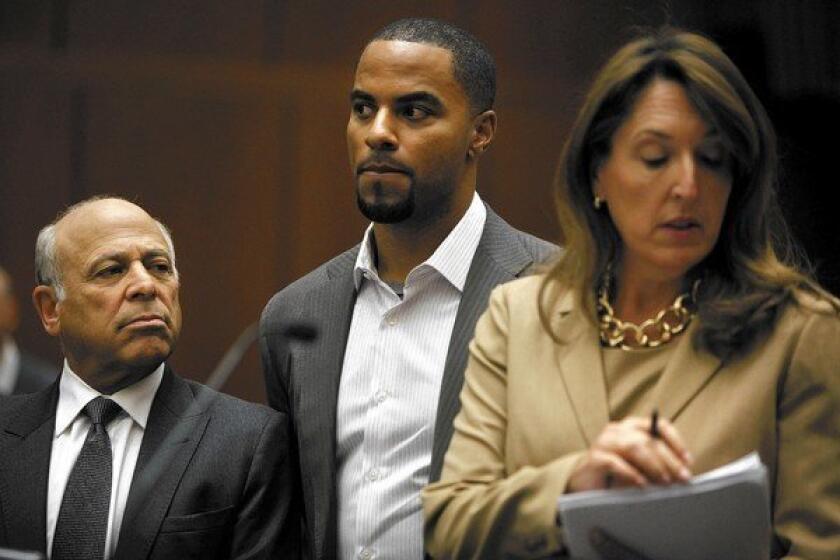 Flanked by attorneys Leonard Levine, left, and Blair Berk, former NFL player Darren Sharper made his first court appearance in Los Angeles last week on charges of drugging and sexually assaulting women he allegedly met at a West Hollywood nightclub. Prosecutors say he's also suspected of assaulting women in three other states.