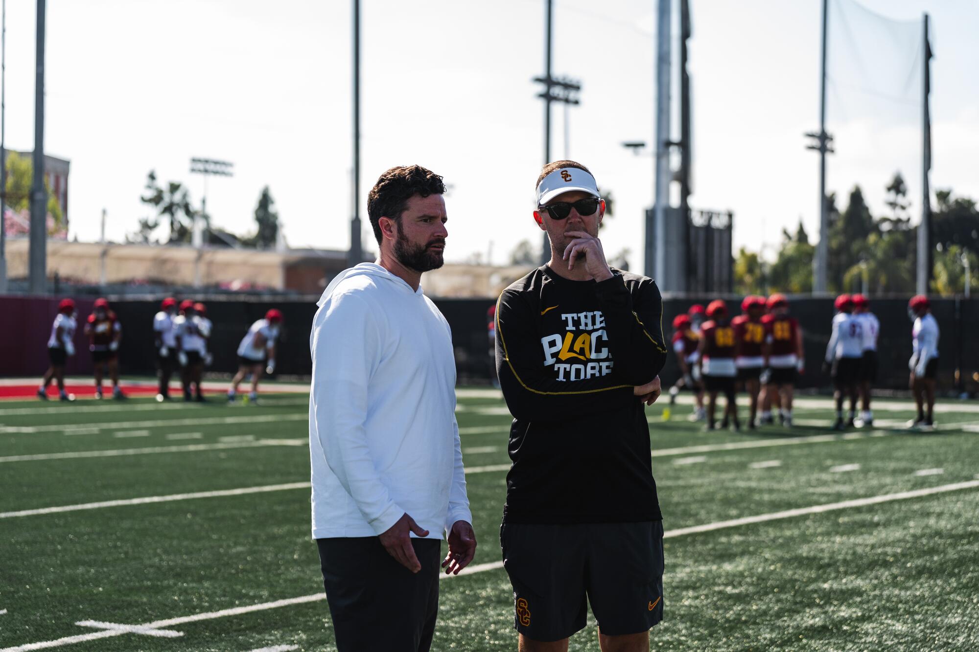 USC football general manager Chad Bowden, left, speaks with coach Lincoln Riley during a recent team practice.