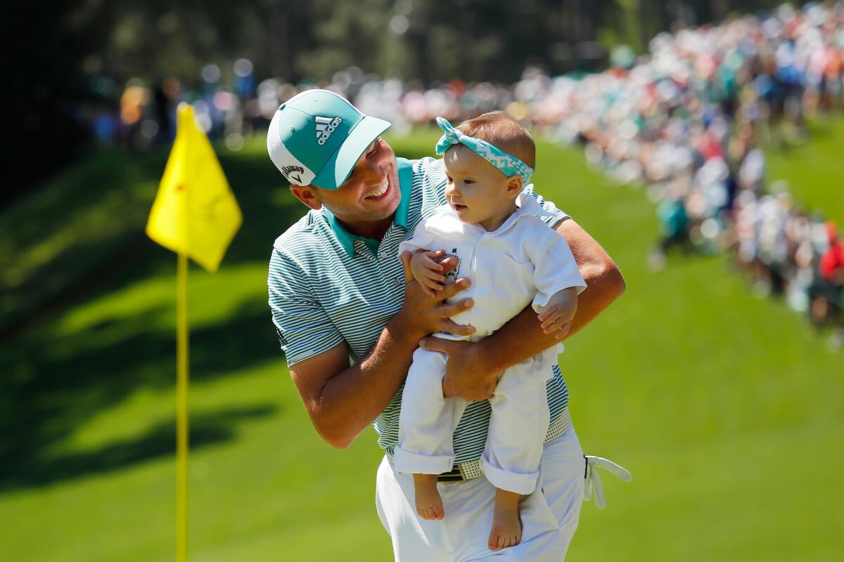 Sergio Garcia of Spain holds daughter Azalea Adele Garcia during the par-three contest prior to the Masters at Augusta National Golf Club on Wednesday in Augusta, Ga.