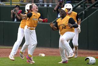 Lake Mary, Fla.'s Hunter Alexander, left, celebrates with teammates after laying down a walk-off bunt.