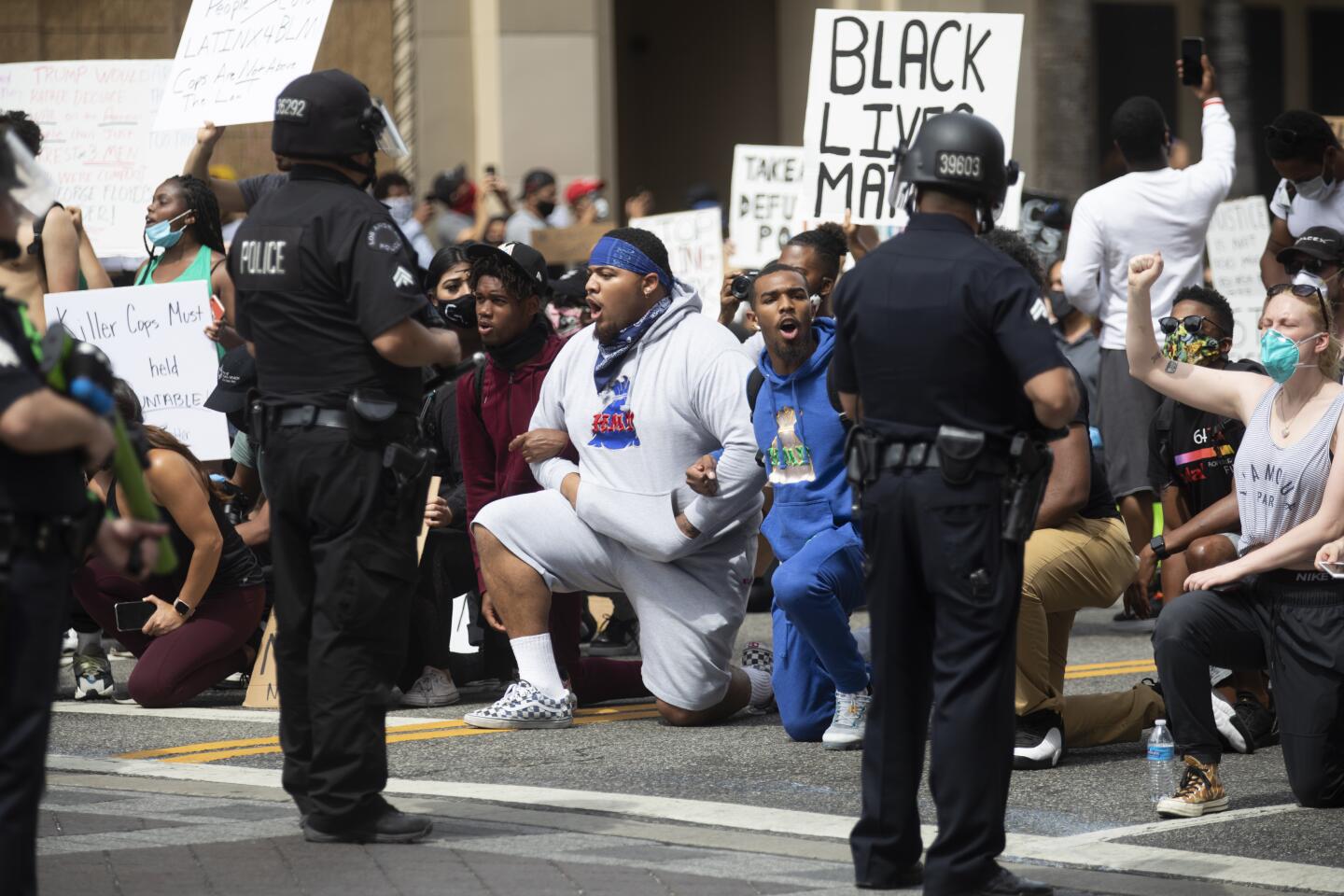 Demonstrators take a knee during protests in Hollywood on Tuesday.