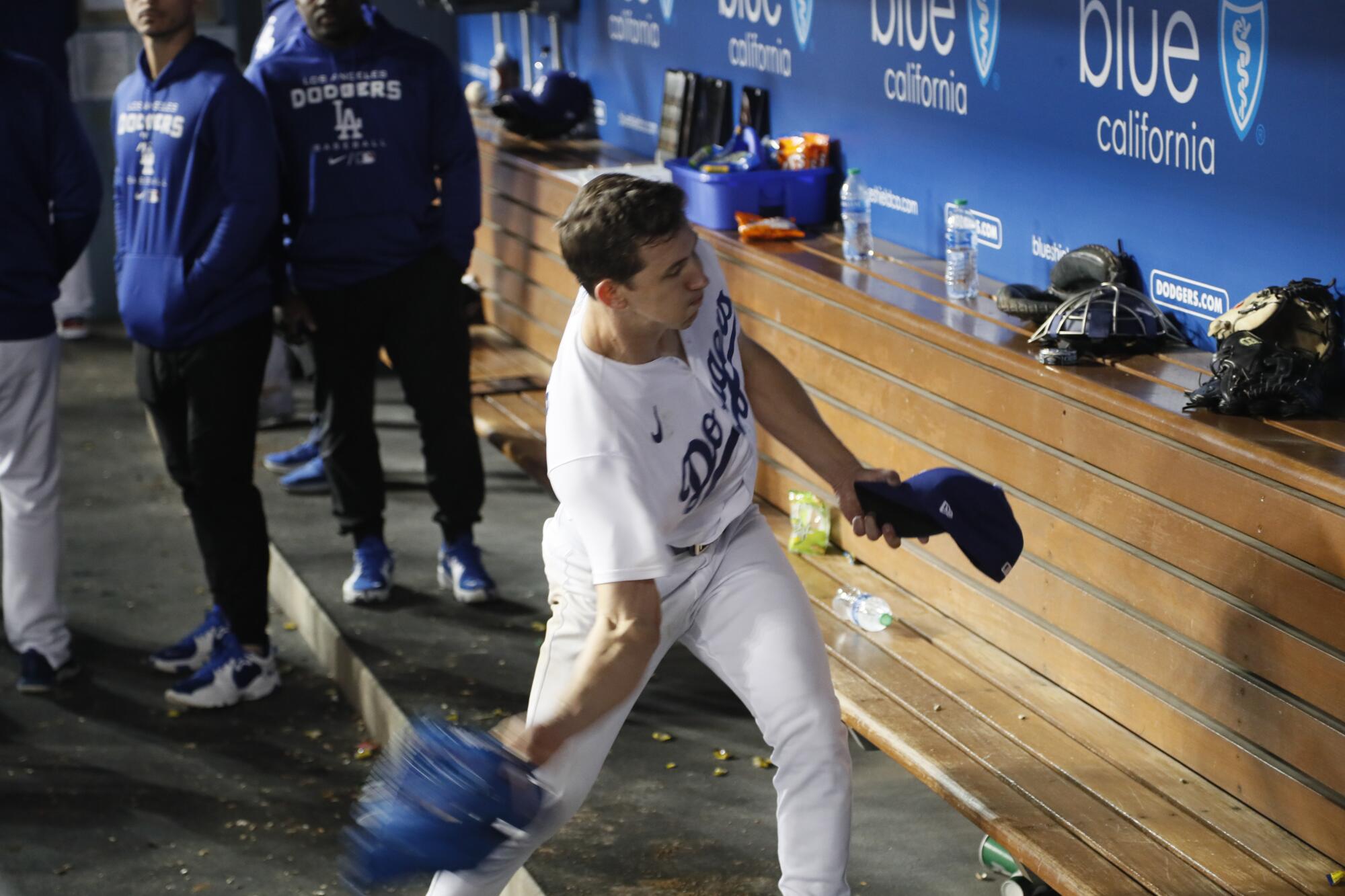 Dodgers starting pitcher Walker Buehler slings his glove in apparent frustration.