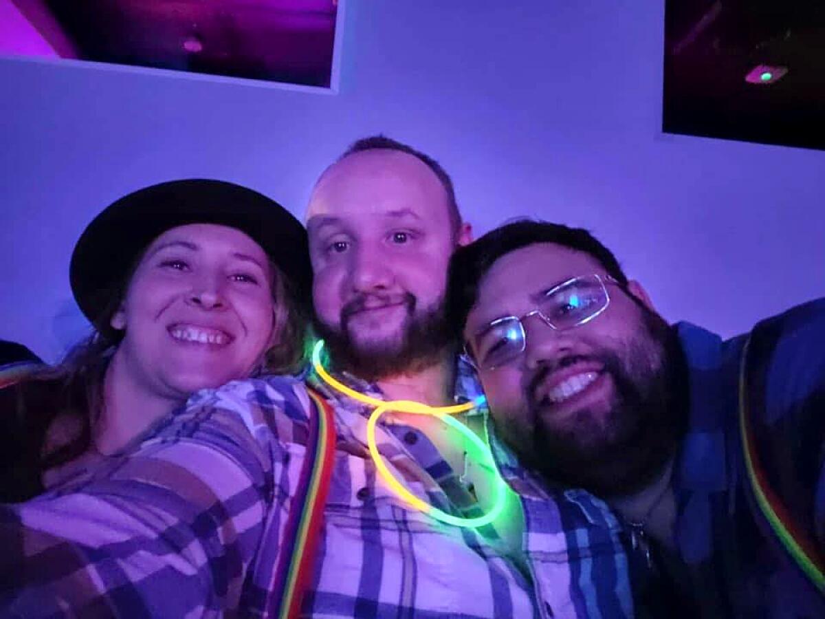Three people in a nightclub