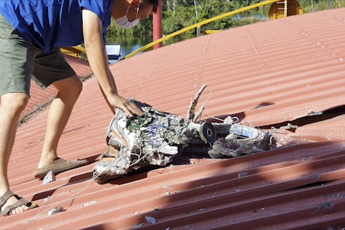 In this image taken from a video footage run by Taiwan's TTV via AP Video, a man checks the roof of a temple where a decorative piece fell and damaged the roof after multiple earthquakes struck the city of Hualien along the eastern coast of Taiwan, Wednesday, July 14, 2021. A series of more than 20 earthquakes struck the east coast of Taiwan on Wednesday morning, causing some damage. (TTV via AP)
