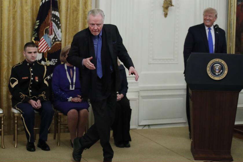 Jon Voight dances as President Donald Trump looks on during a National Medal of Arts and National Humanities Medal ceremony in the East Room of the White House, Thursday, Nov. 21, 2019, in Washington. (AP Photo/Alex Brandon)