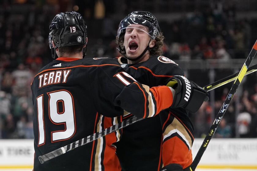 Anaheim Ducks left wing Rickard Rakell, right, celebrates his game-winning goal with Troy Terry.