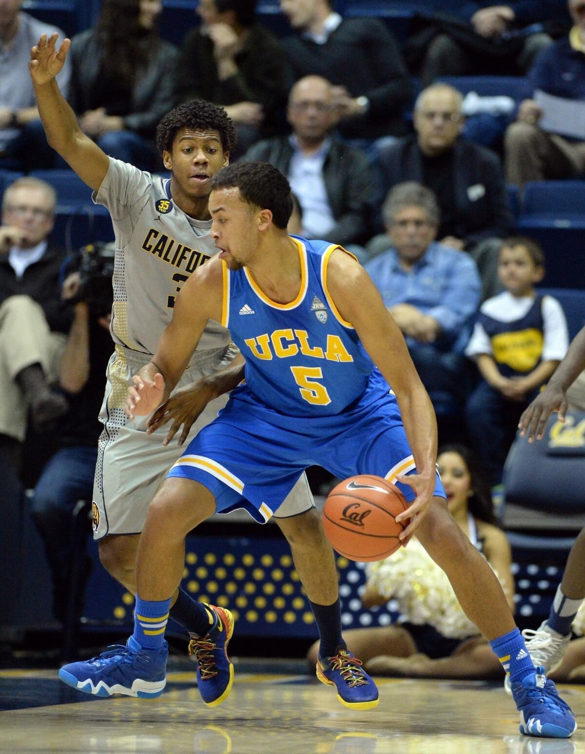 UCLA's Kyle Anderson is defended by California's Tyrone Wallace during the first half of the Bruins' 86-66 win Wednesday over the Golden Bears at Haas Pavilion in Berkeley, Calif.