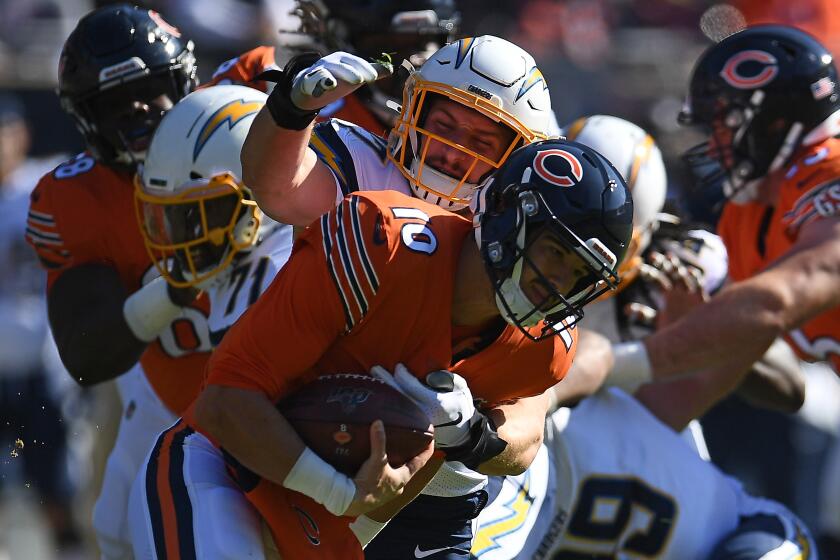 CHICAGO, ILLINOIS - OCTOBER 27: Mitchell Trubisky #10 of the Chicago Bears is brought down by Joey Bosa #97 of the Los Angeles Chargers during the first quarter of a game at Soldier Field on October 27, 2019 in Chicago, Illinois. (Photo by Stacy Revere/Getty Images)