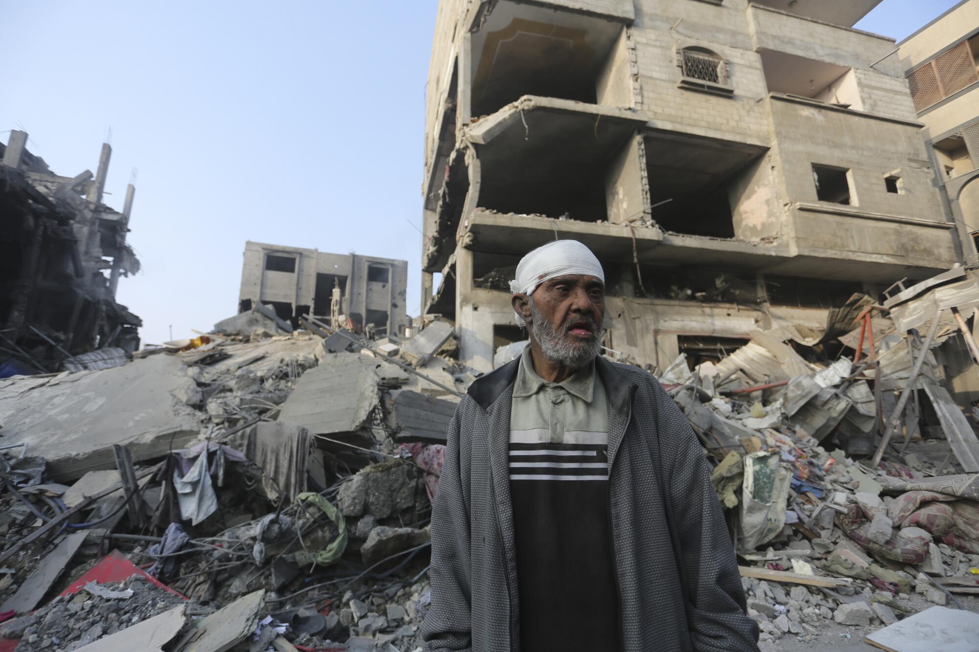 Man outside a Gaza building destroyed by Israeli bombardment