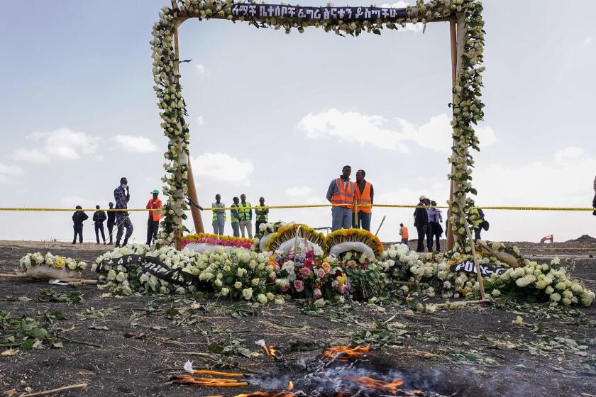 EJERE, ETHIOPIA - MARCH 14: Candles burn before a flower adorned memorial arch erected at the site of the Ethiopian Airlines Flight ET302 crash on March 14, 2019 in Ejere, Ethiopia. All 157 passengers and crew perished after the Ethiopian Airlines Boeing 737 Max 8 Flight came down six minutes after taking off from Bole Airport. (Photo by Jemal Countess/Getty Images) ** OUTS - ELSENT, FPG, CM - OUTS * NM, PH, VA if sourced by CT, LA or MoD **