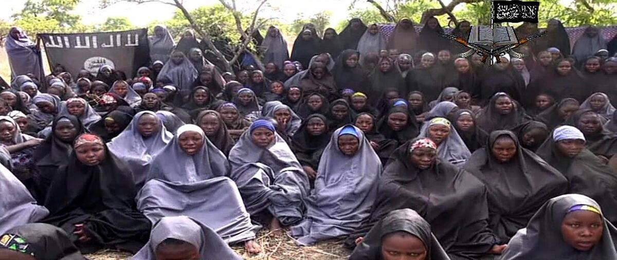 A screengrab taken on May 12 from a video of Nigerian Islamist extremist group Boko Haram purports to show kidnapped schoolgirls wearing the full-length hijab and praying in an undisclosed rural location.