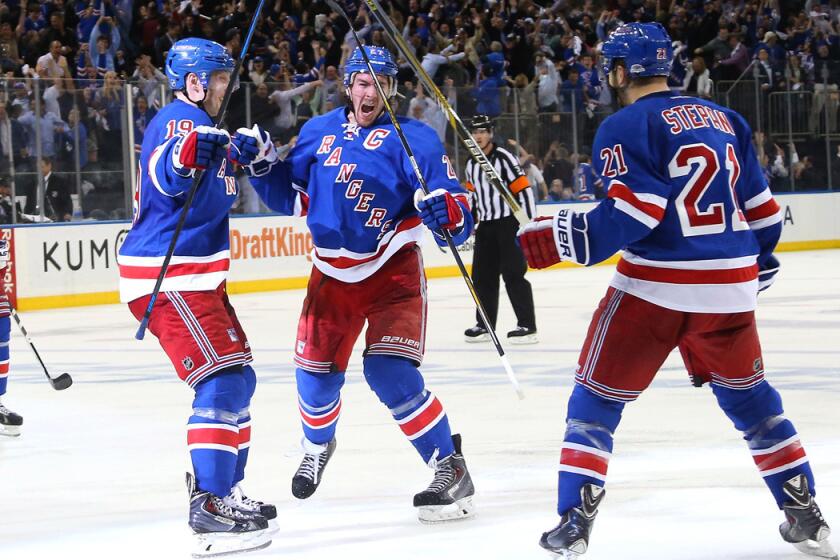 New York Rangers' Ryan McDonagh, center, celebrates his game winning goal at 9:37 of overtime against the Washington Capitals and is joined by Jesper Fast, left, and Derek Stepan in Game 5 of the Eastern Conference semifinals of the Stanley Cup Playoffs on Friday.