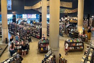 Visitors peruse through books and records inside of The Last Bookstore in Downtown Los Angeles.